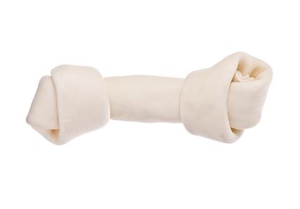 Close-up of a rawhide treat in the shape of a bone on a white background