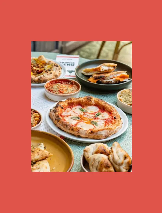 A green table with a mix of vegan Italian dishes on.