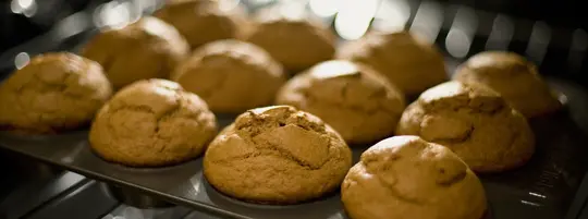 A tray of cupcakes baking in the oven