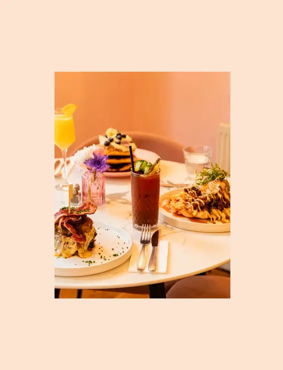 White round table with a range of brunches and cocktails on it.