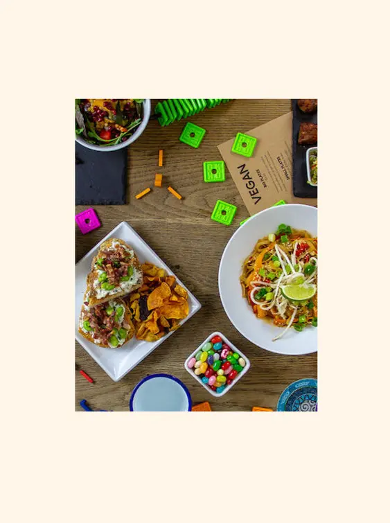 A mixture of food and board games on a table