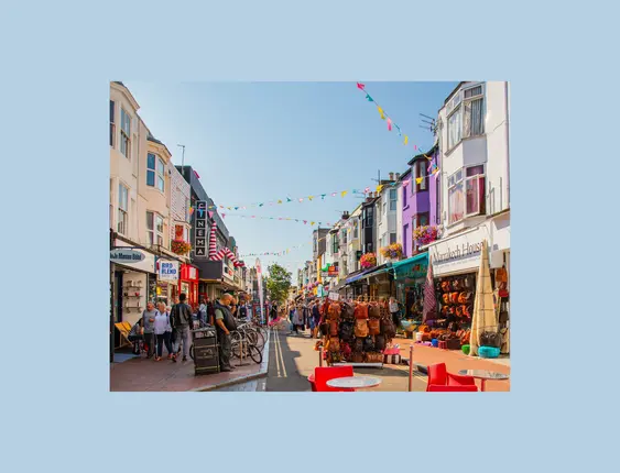 colourful shopping street with racks of items on the road
