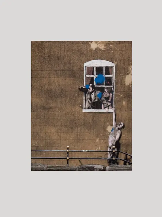 Bansky street art of man holding onto window ledge