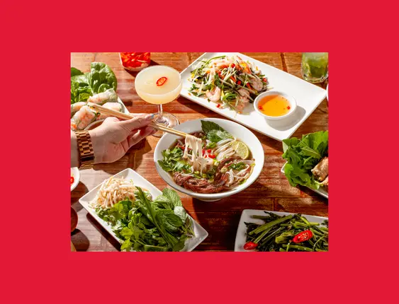 hand holding chopsticks picking up Vietnamese food