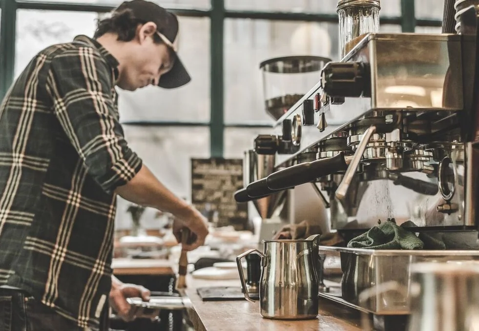 Man brewing coffee inside Spitfire Espresso, a Glasgow-based coffee shop