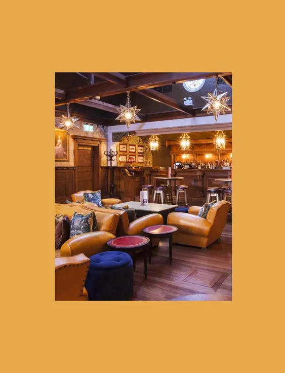 Opulent restaurant interior with plush seating, ornate lighting, and a classic wooden bar.