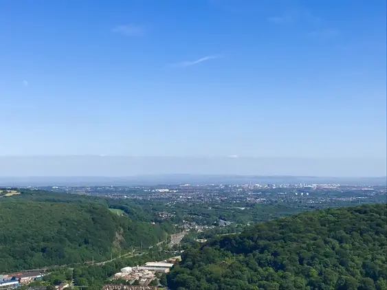Image from the peak of Garth Mountain, Cardiff appears on the horizon on a bright, blue day