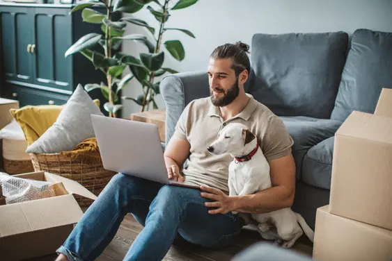 Man and dog looking at laptop
