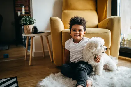 A toddler with a dog