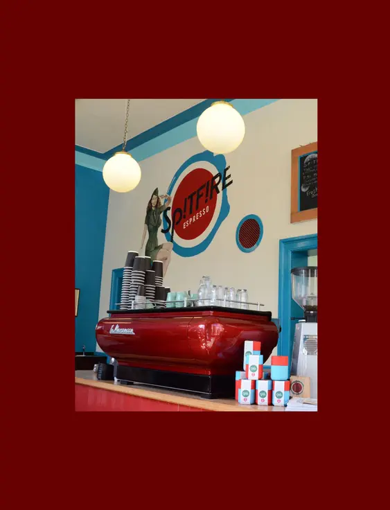 Inside Spitfire Espresso, showcasing a vibrant and inviting interior with a classic espresso machine and colourful decor.