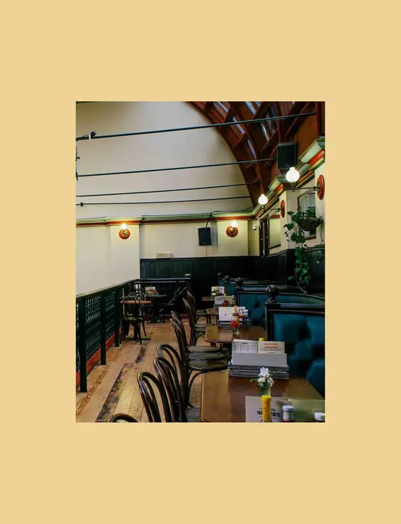 Spacious pub interior featuring a high arched ceiling and elegant balcony seating.