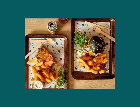 wooden trays with vegan fish and chips on them