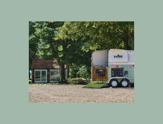 A picturesque county scene with a horse trailer converted into an ice-cream stall.
