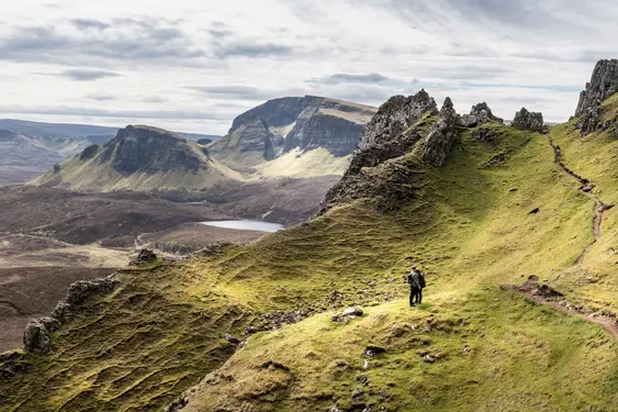 Image of mountains and two people on a walk on the Isle of Skye, Scotland