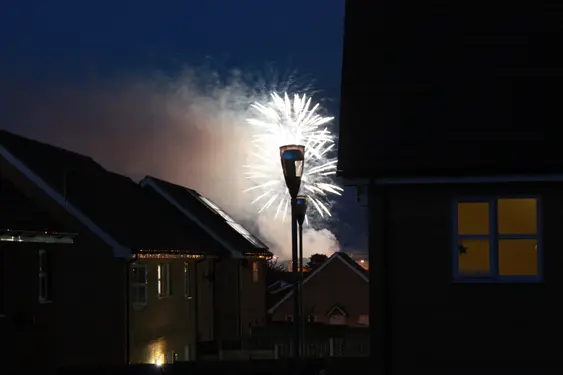 A few fireworks go off over a housing estate in Britain
