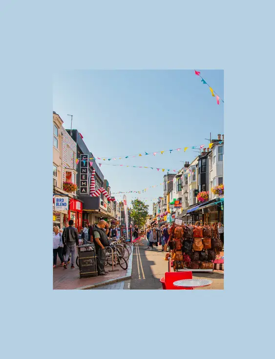 colourful shopping street with racks of items on the road