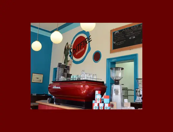 Inside Spitfire Espresso, showcasing a vibrant and inviting interior with a classic espresso machine and colourful decor.