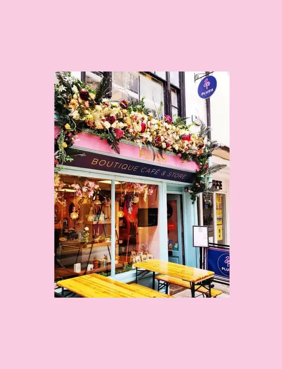 Front of the Plush Cafe, with flowers above the café window.