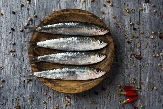 Sardines on a wooden plate