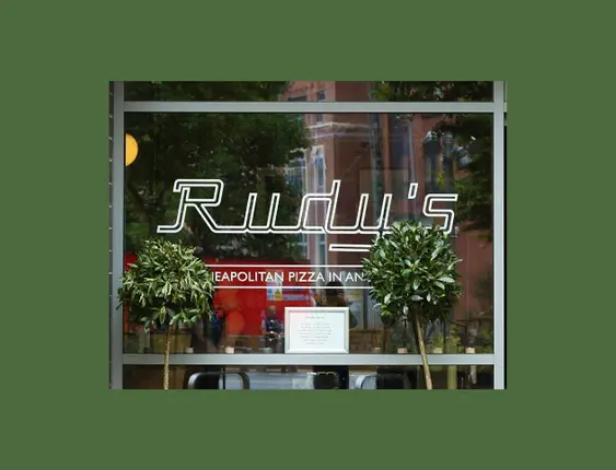 Rudy's Pizza shopfront: modern glass facade with large windows, featuring neon signage.
