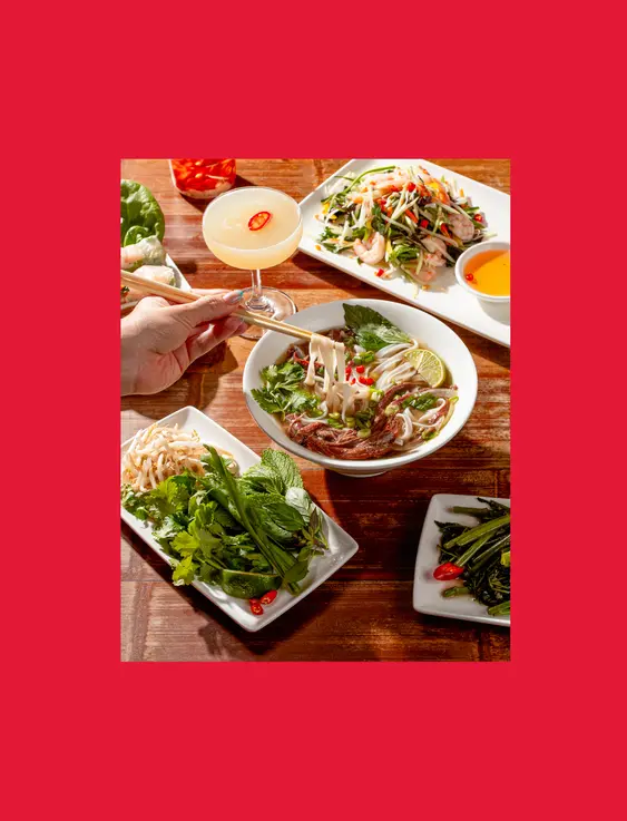 hand holding chopsticks picking up Vietnamese food