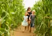 Family running through a field of maize