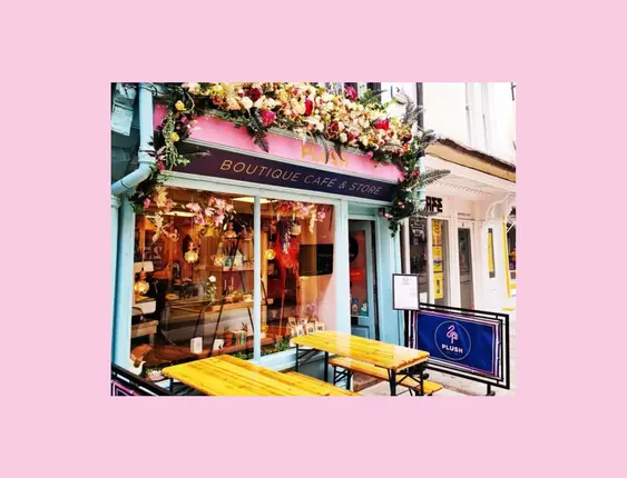 Front of the Plush Cafe, with flowers above the café window.