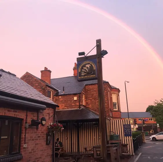 Image of Bread and Bitter pub, Nottingham with a rainbow in the sky